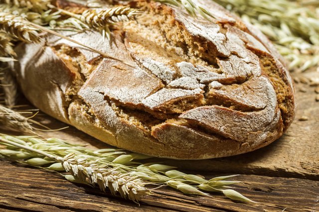 Wholemeal bread on old wooden table
