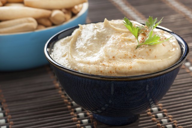 bowl of homemade hummus with breadsticks