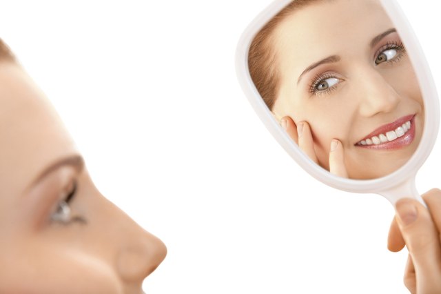 Beautiful female looking in a mirror