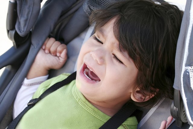 Unhappy toddler crying in stroller