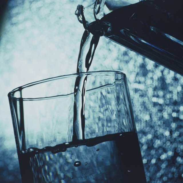 Water being poured into glass, close-up
