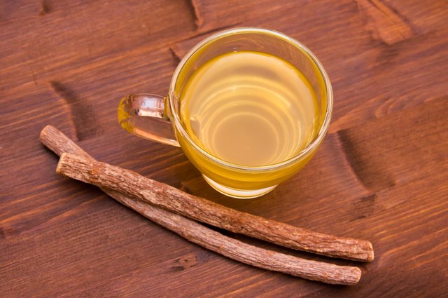 Herbal tea licorice inside cup on wood from above