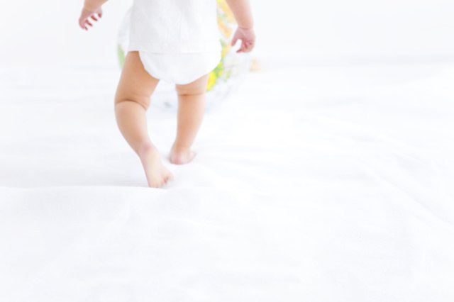 Baby girl playing with globe beach ball