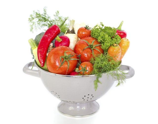 Fresh vegetables in metal colander