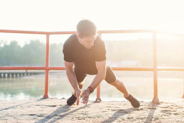 Fitness man doing clapping push-ups exercise intense training outdoors