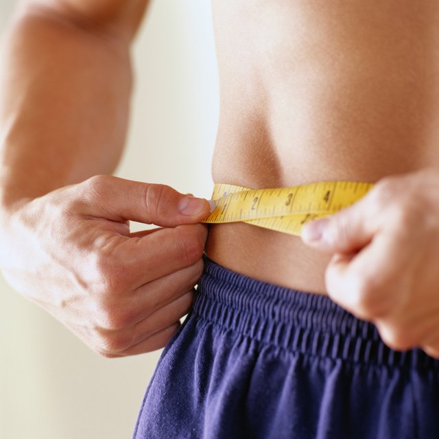 Close-Up of a Man Measuring His Waist