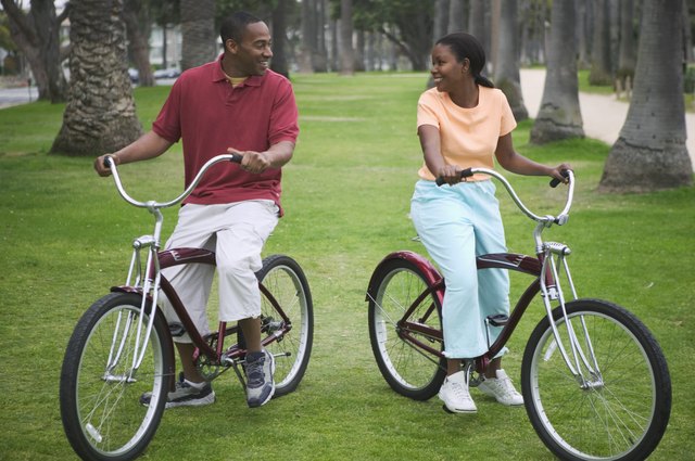 Mid adult couple sitting on bicycles