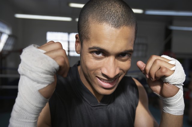 Man wearing wristbands in fighting stance, close-up