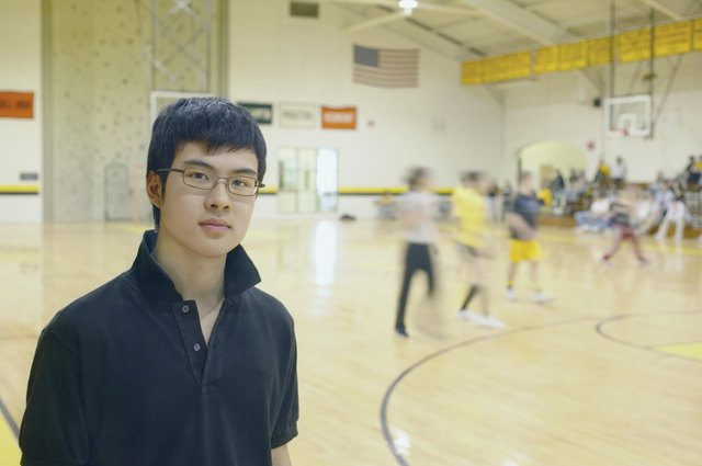 Teenage boy standing on basketball court