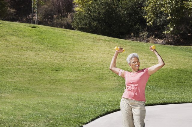 Senior woman posing with weights