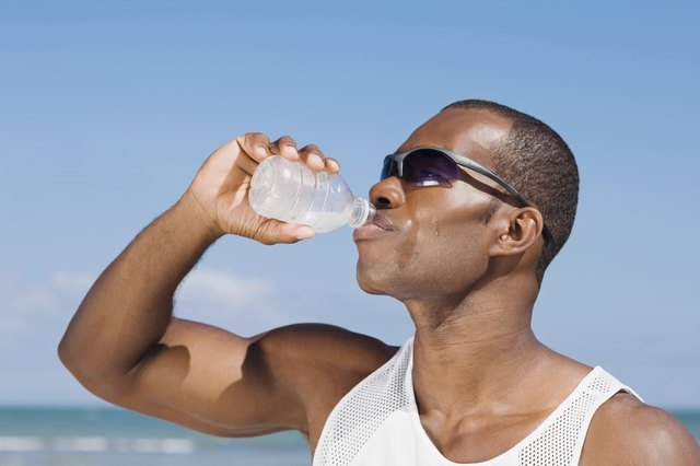 African man drinking water bottle