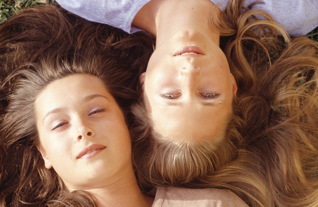 Two young women lying, portrait, overhead view, close-up