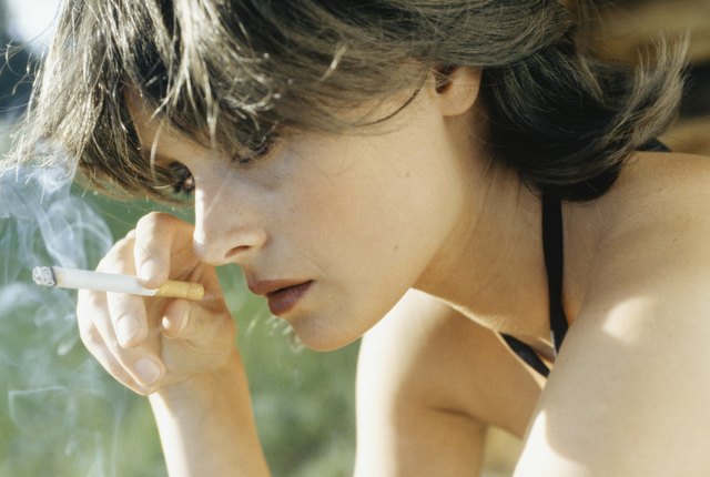 Young woman smoking cigarette, close-up