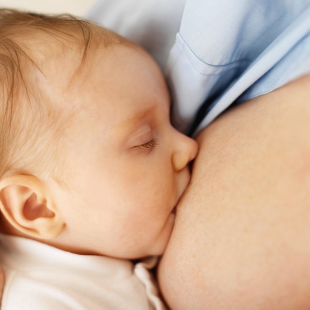 close up view of a baby (6-12 months) breastfeeding