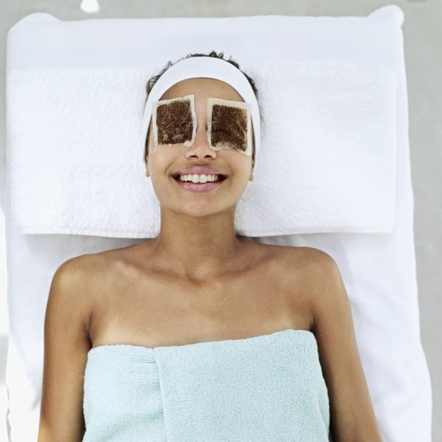 woman lying down with eye patches
