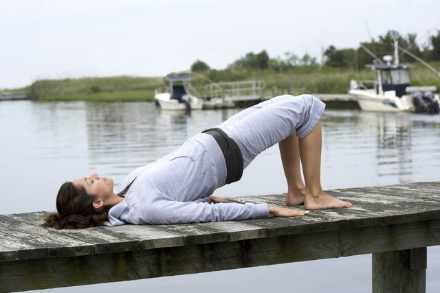 Woman exercising on pier