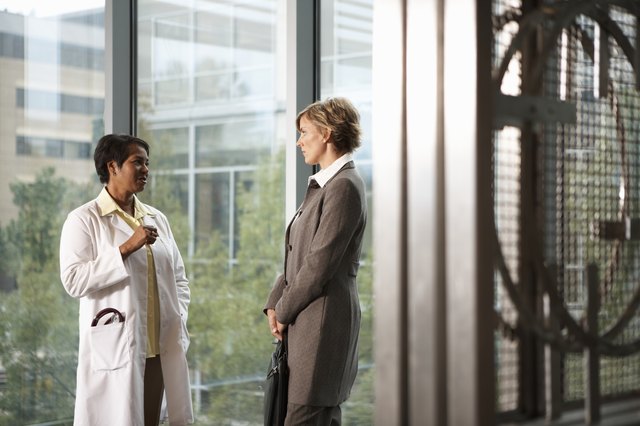 Doctor and businesswoman talking