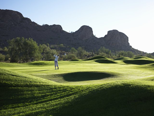 Man playing golf on course