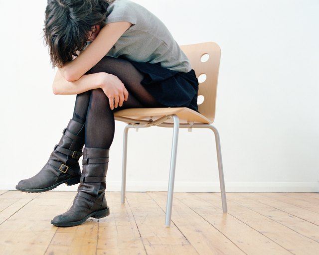Sad woman on chair
