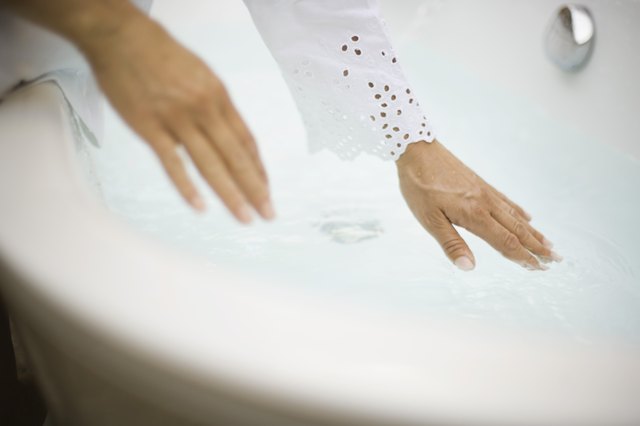 Woman testing bath water