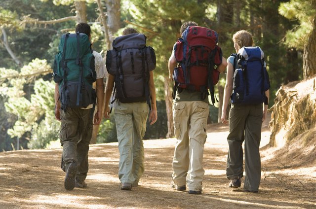Couples backpacking in woods