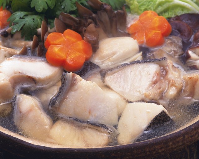Vegetable and cods in pot, high angle view