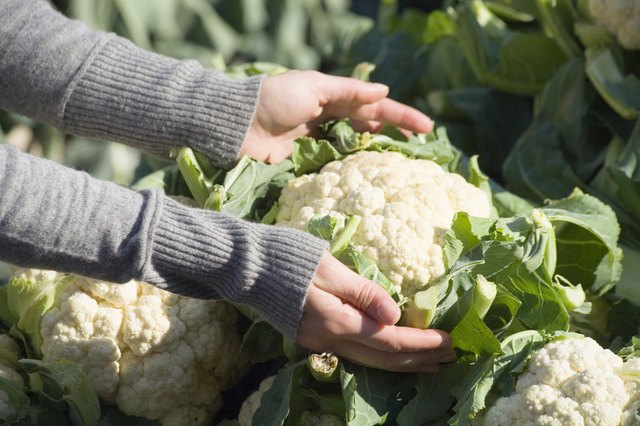 Person holding fresh cauliflower