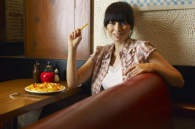 Woman Eating French Fries
