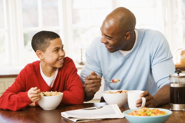 Father and son eating cereal
