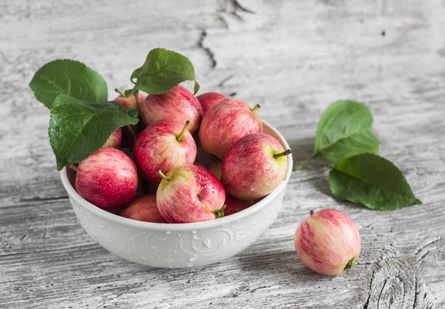 fresh red apples in a white bowl
