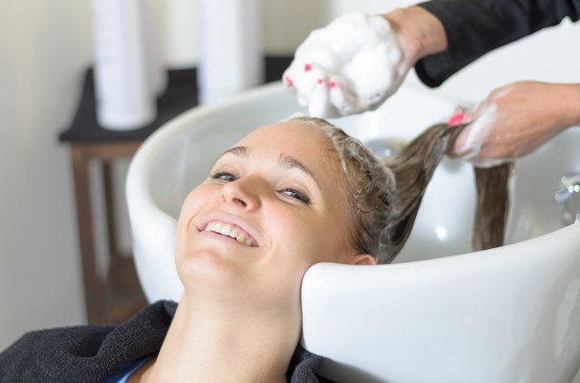 Woman having her hair shampooed