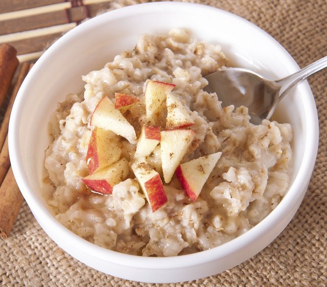 Oatmeal with apples and cinnamon in a white bowl