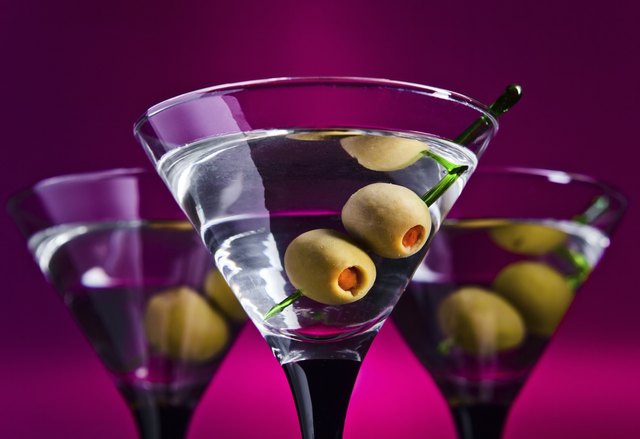 glasses with martini and green olives