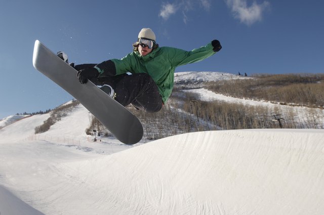 Teenage snowboarder jumping