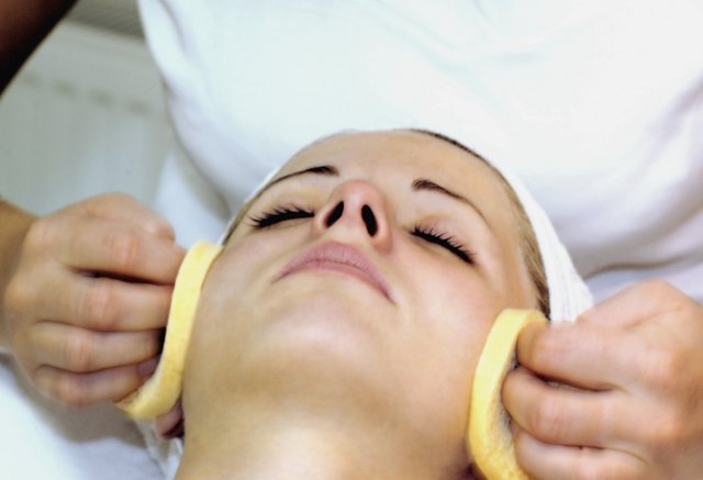Close-up of a person's hand wiping a mid adult woman's face