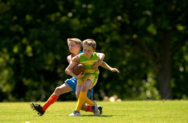 Young football player tackles opposition