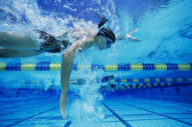 Swimmers Racing in Pool