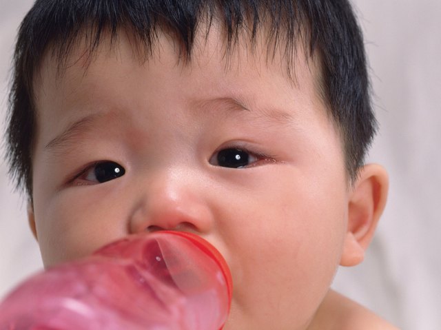 Close up of babys face, drinking milk, front view, portrait, Full Frame