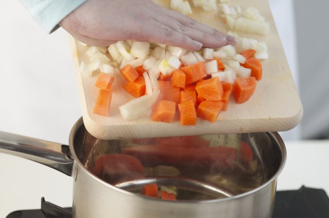 Person cooking with vegetables, close up
