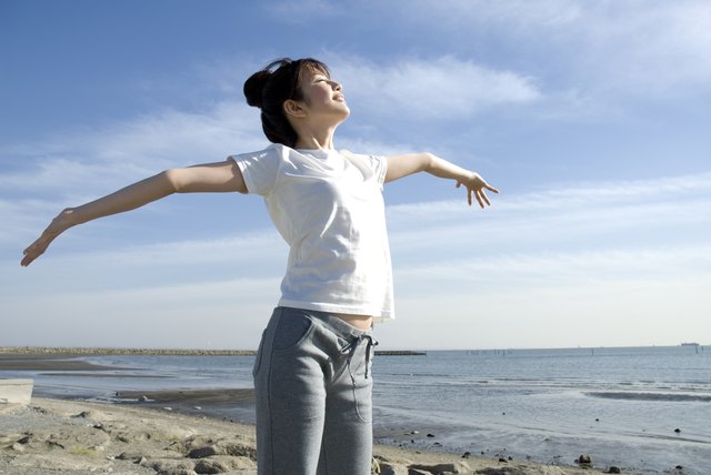 Young Woman Stretching Out Her Arms, Low Angle View, Side View