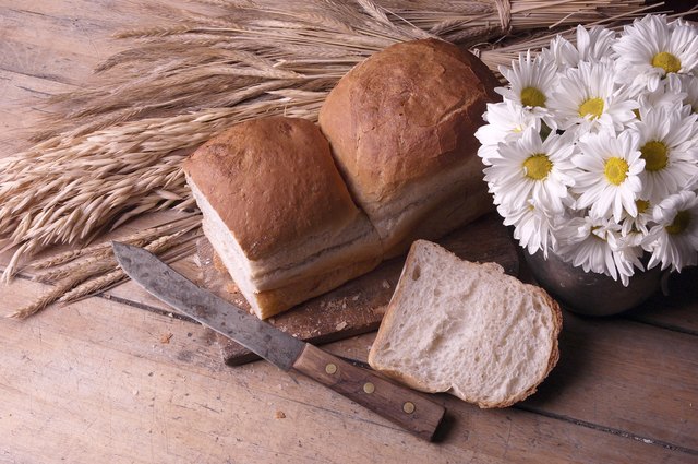 Daisies in rustic jug with bread loaf