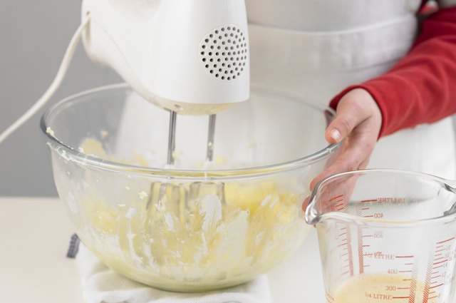 Person using electric whisk, close up