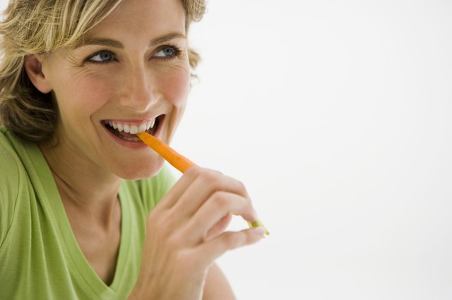 Woman eating carrot