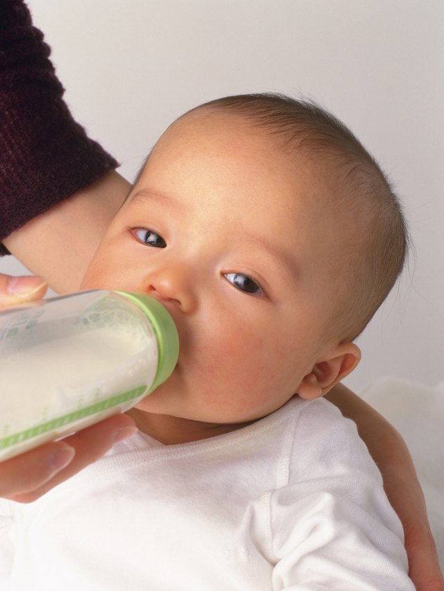 Mother feeding baby boy, portrait, side view