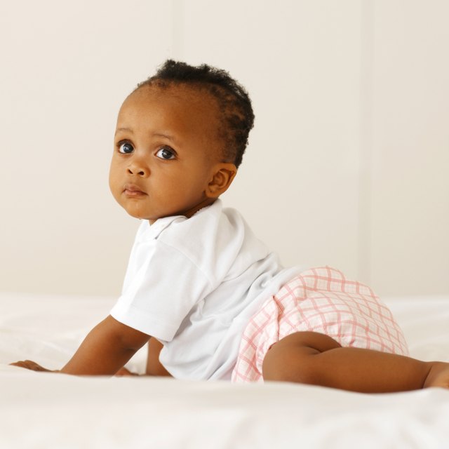 portrait of a baby (12-18 months) crawling