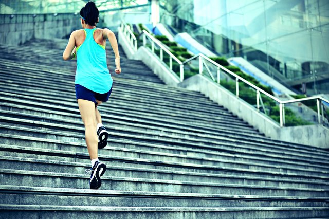young sports woman running up on stone stairs