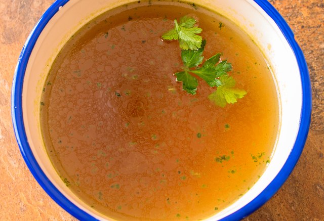Beef soup with parsley close up