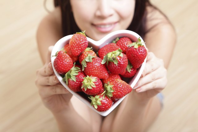 Woman smiling with strawberry