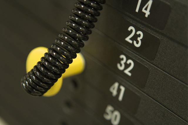 Weights on an exercise machine in gym, high angle view, close up, differential focus