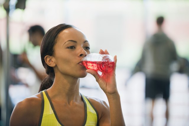 Young woman drinking sports drink